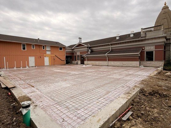 June 2026 — Foundation slab, Mandir shikhara in background